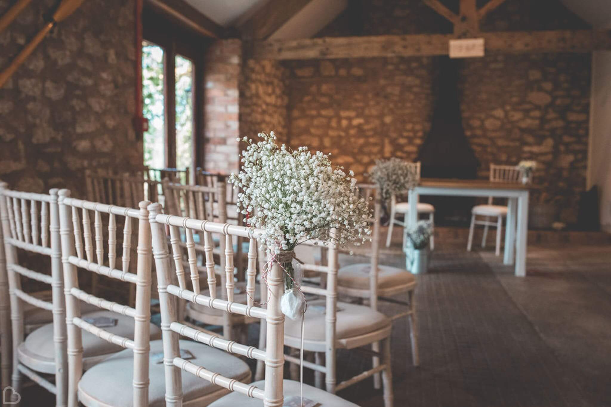 quantock lakes wedding venue, a detail of flowers on a chair ready for wedding ceremony.