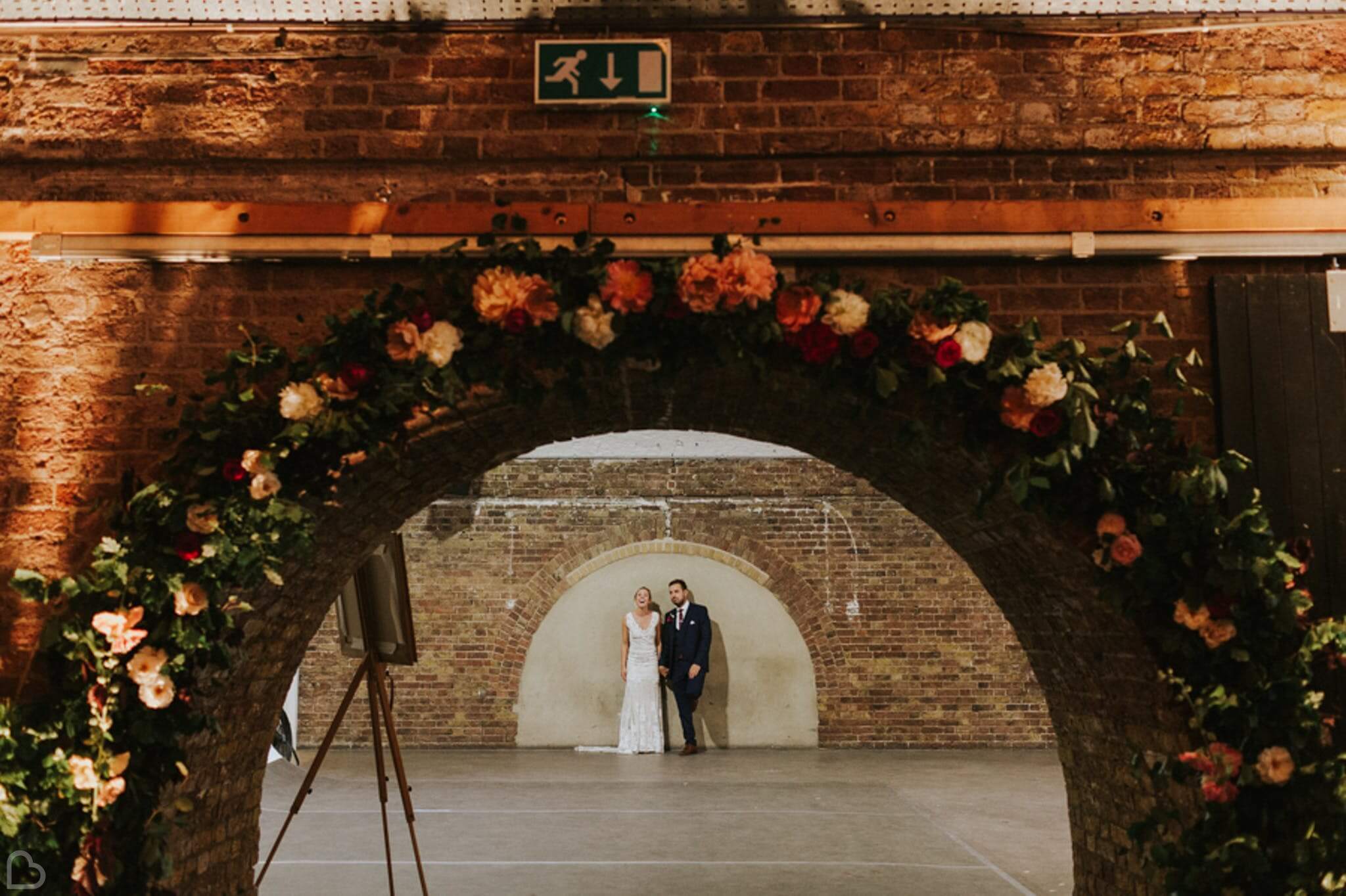 Bride and groom looking cheerful in their wedding venue, Shoreditch Studios. 