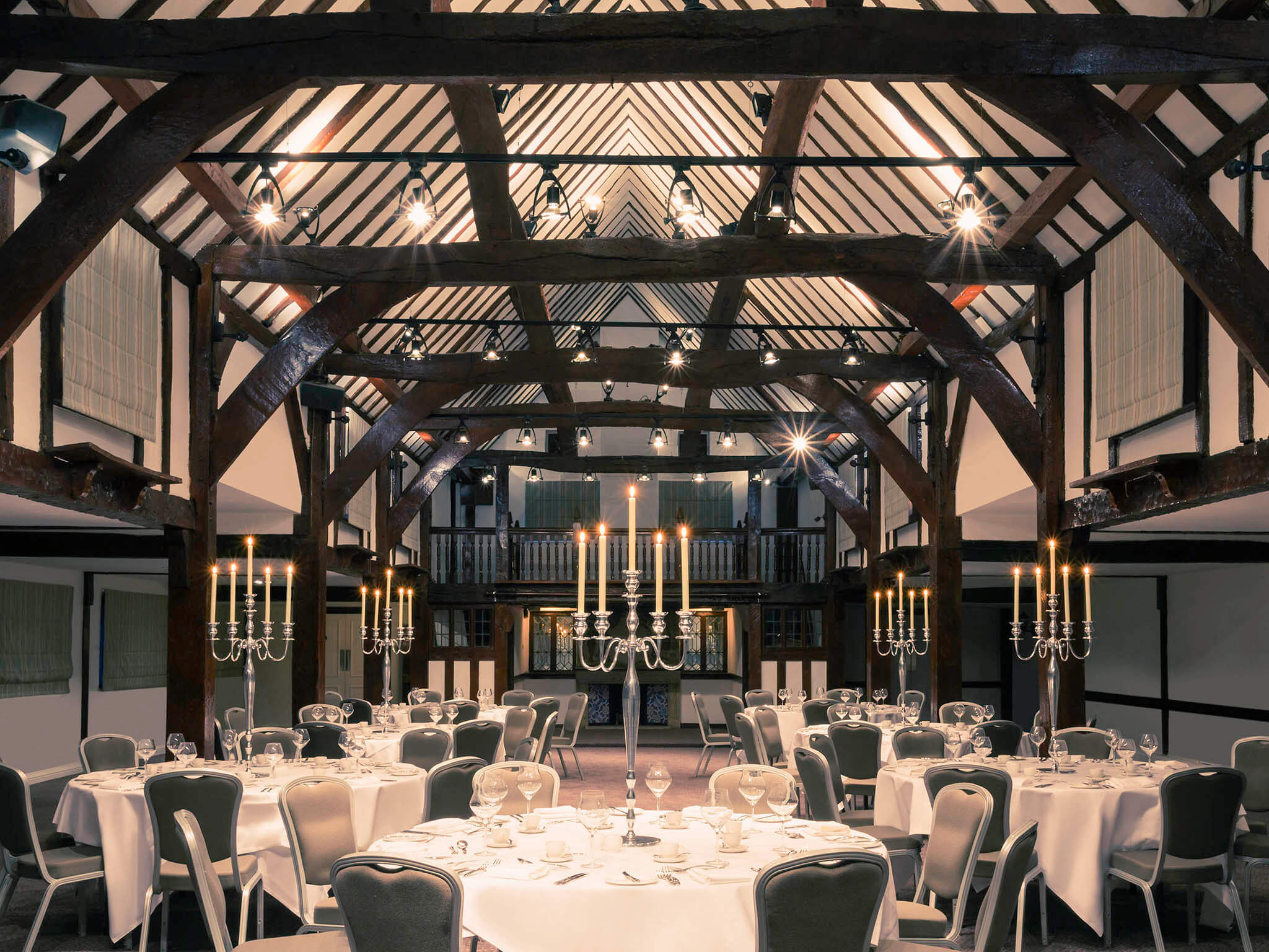 mercure box hill burfold bridge hotel with candles lit for a wedding dinner