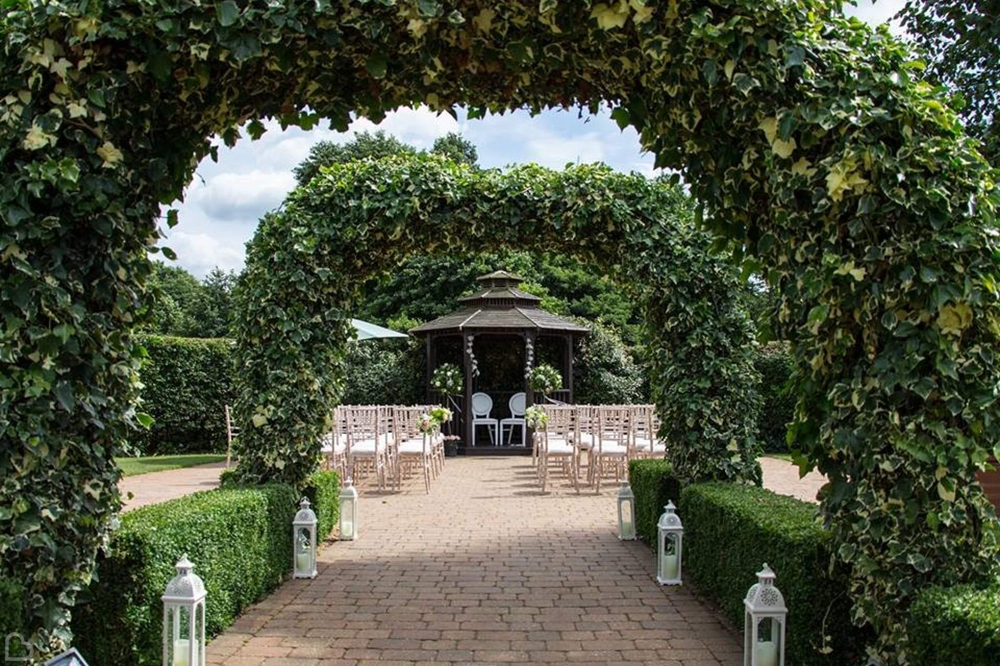 tewin bury farm hotel with green arches set up for wedding ceremony