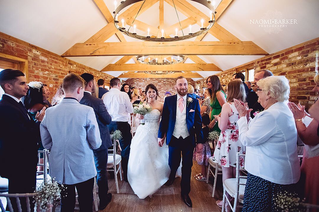 apton hall wedding venue newlyweds exiting the ceremony as guests cheer