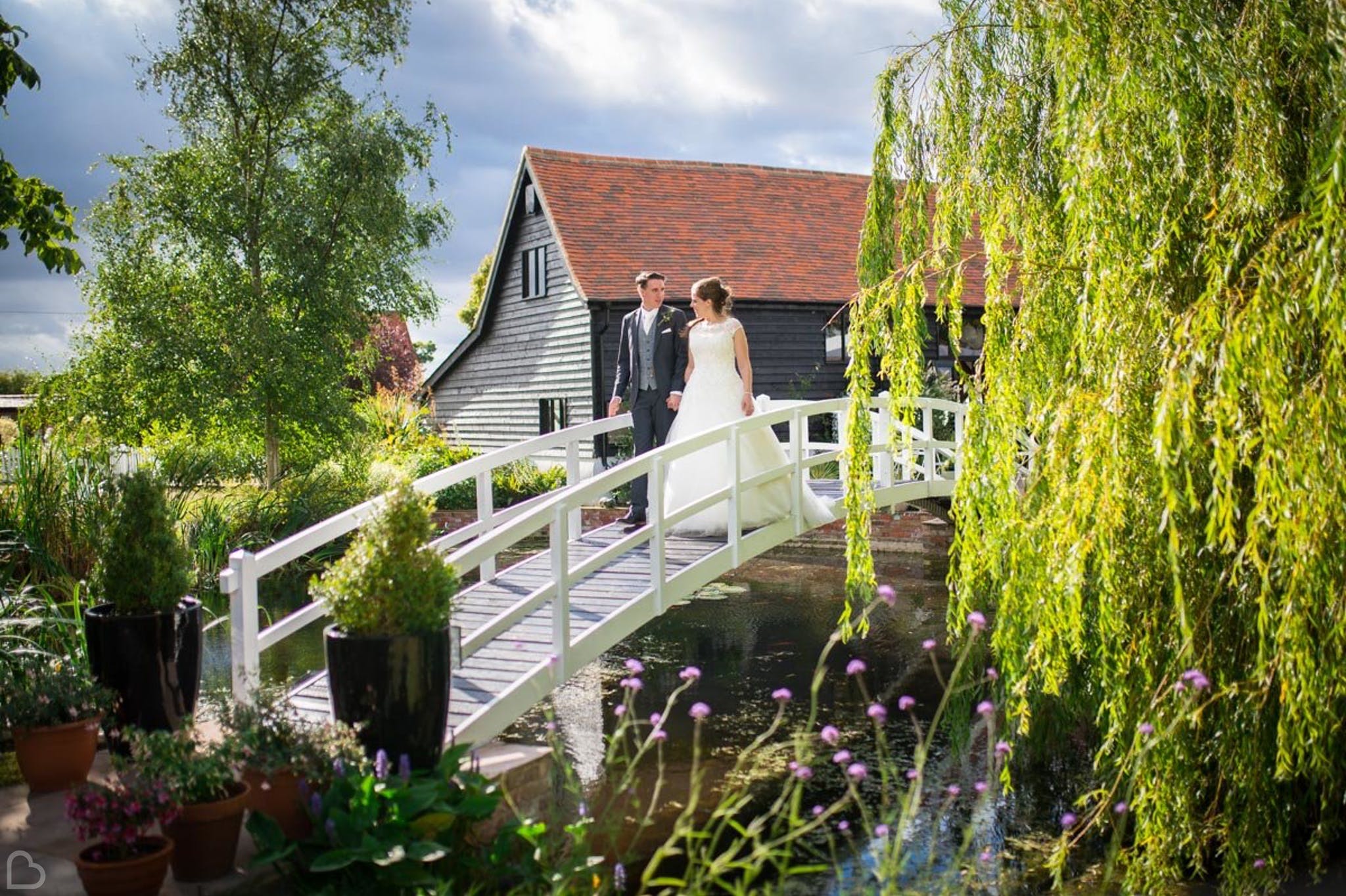 newlyweds crossing the bridge at high house weddings