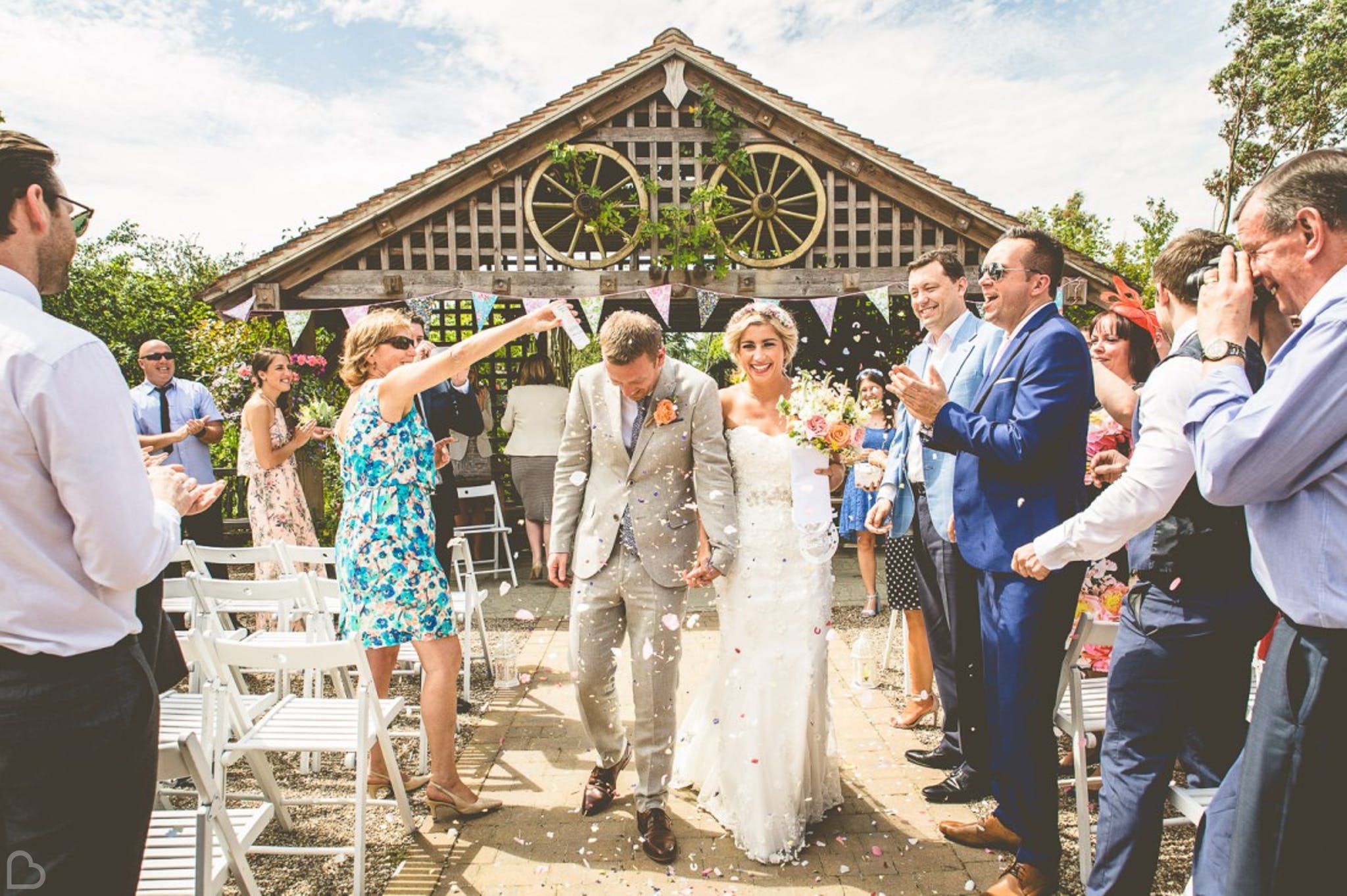 newlyweds and guests confetti shot at Maidens Barns