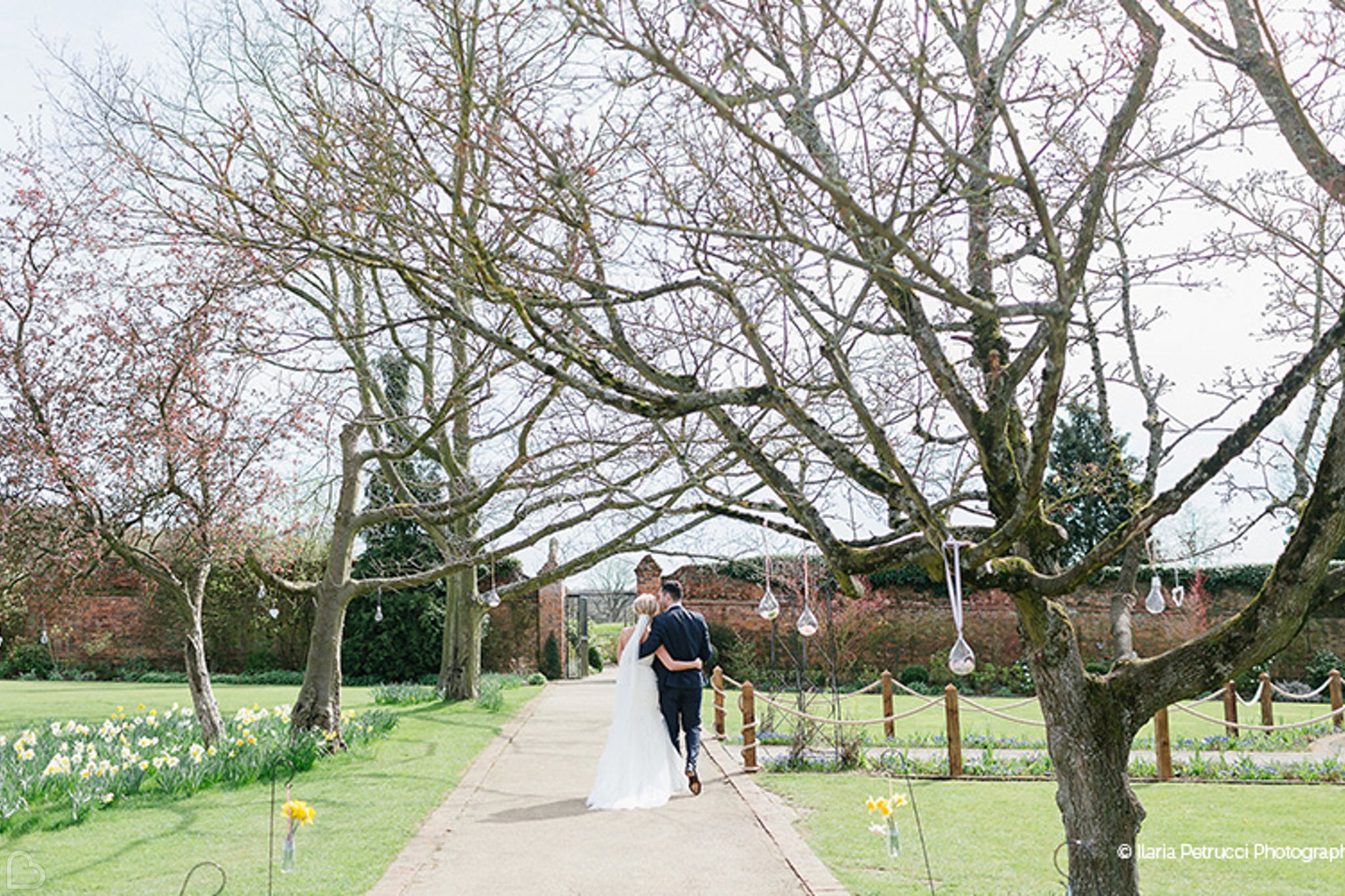 Newlyweds walking through Gaynes Park wedding venue in Essex