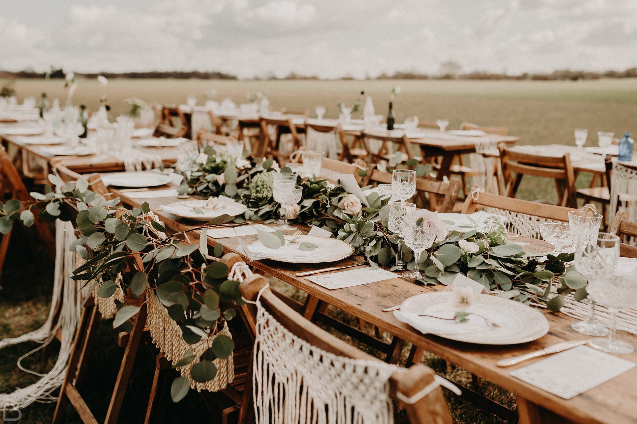 Tables set for a boho wedding at The Barns at Lodge Farm, a wedding venue in essex.