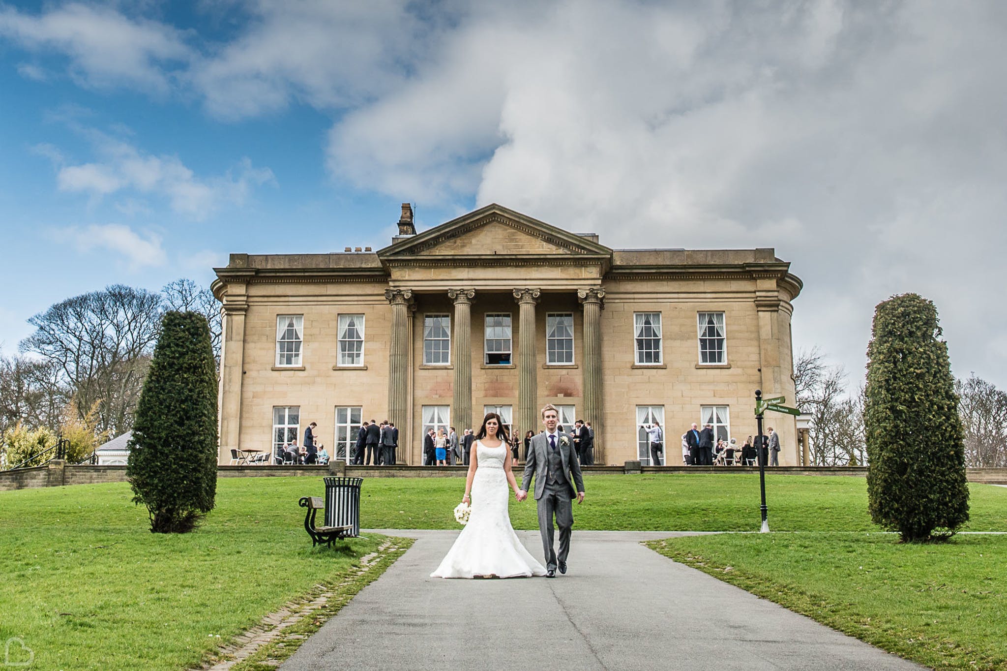 Newlyweds walking in The Mansion gardens.