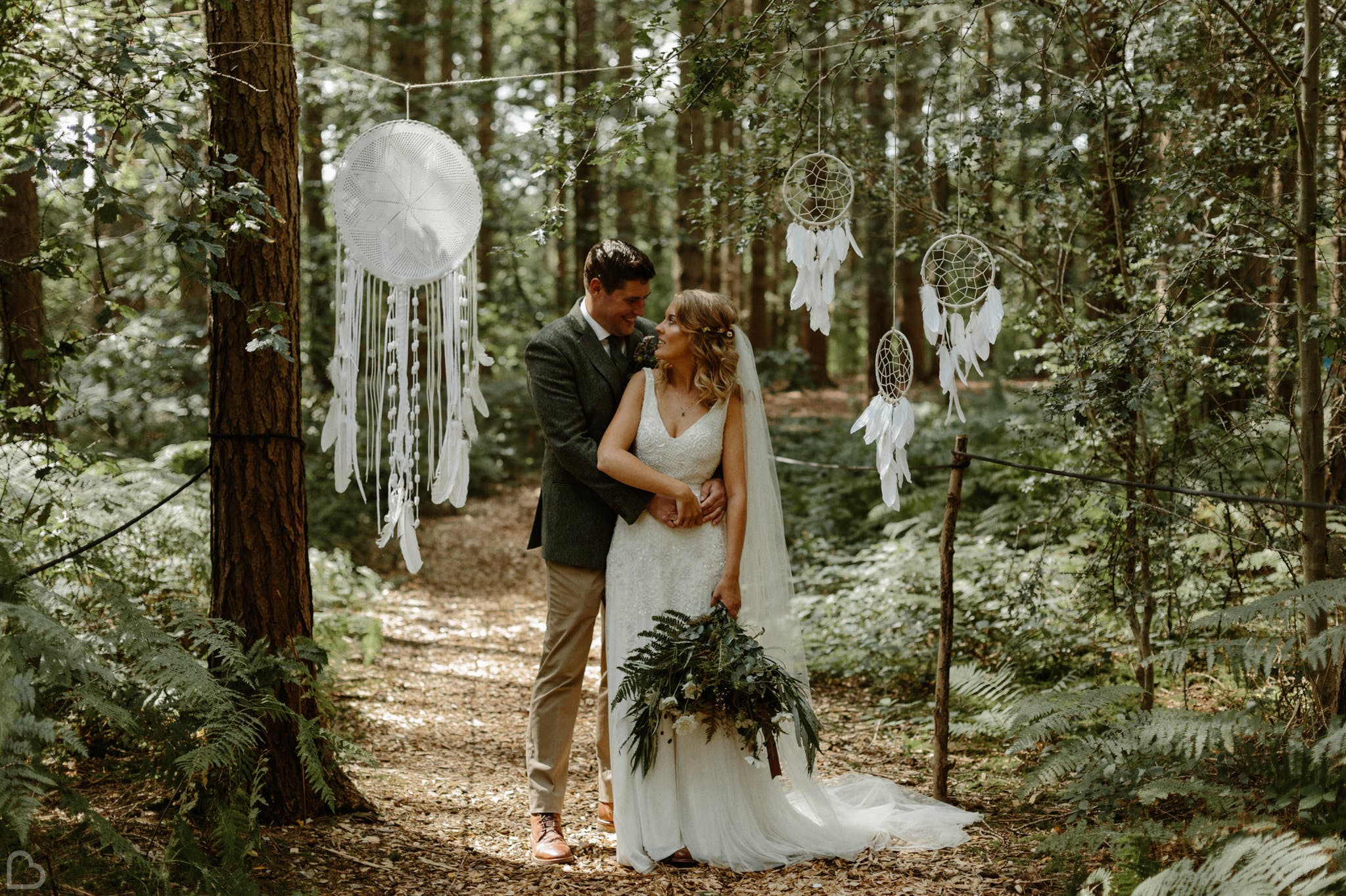 Newlyweds in the forrest at Camp Katur, a woodland wedding venue.