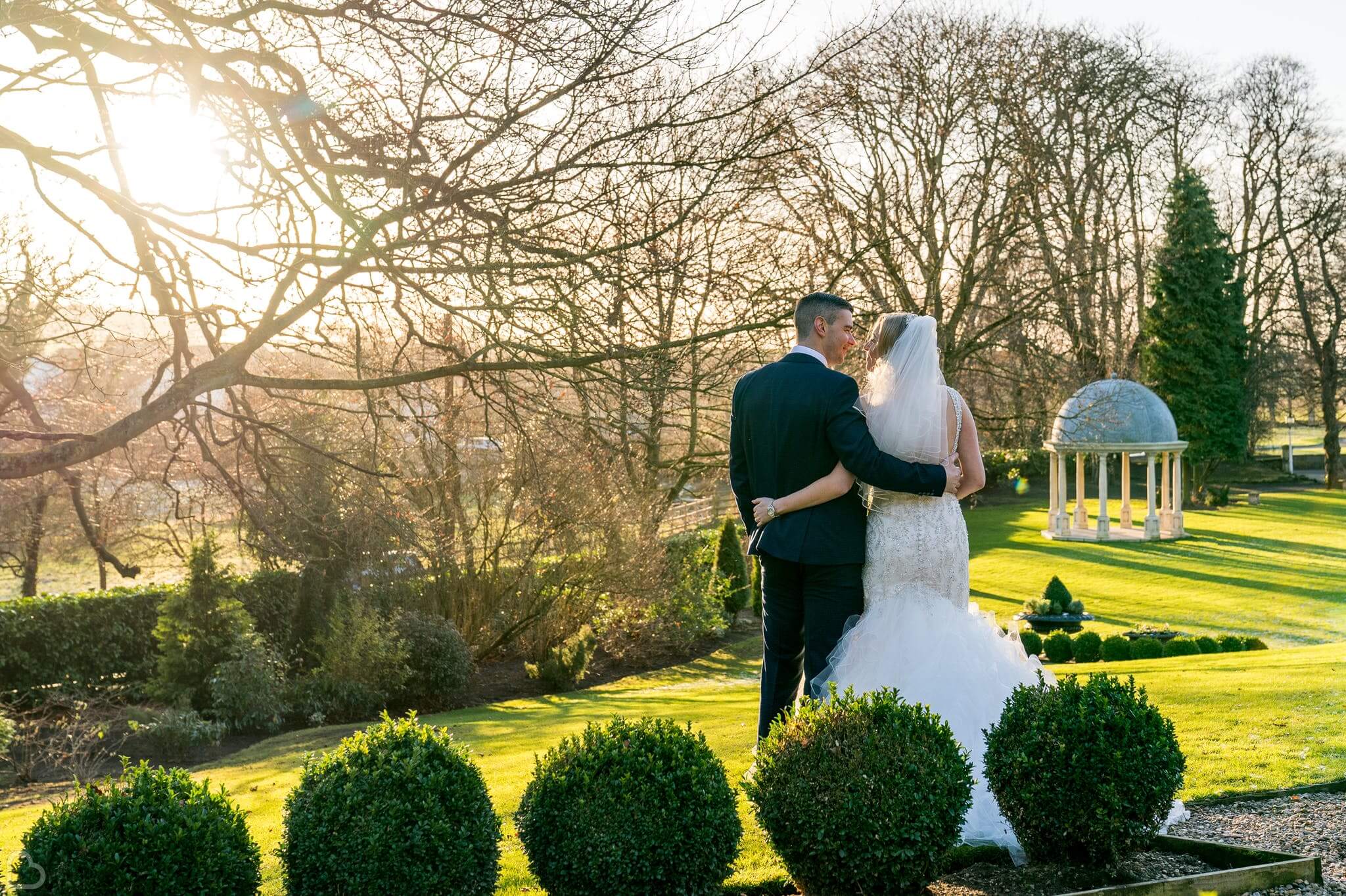 Couple embrace in the gardens of Wentbridge House Hotel