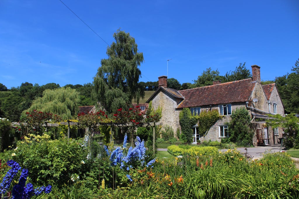 Gants Mill Garden blooming with colourful flowers on a blue skies day.