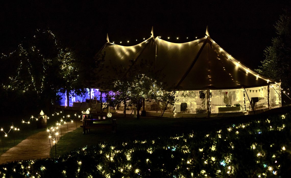 Tipi style marquee lit with fairly lights at Lodge farm House