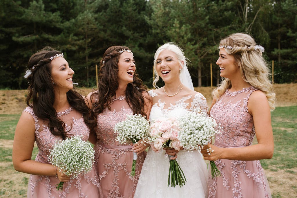 Bride and her bridesmaids pose outside The Glade at Rosliston Forestry Centre