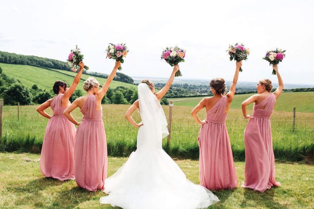 Bride and her bridesmaids pose at Little Wold Vineyard,