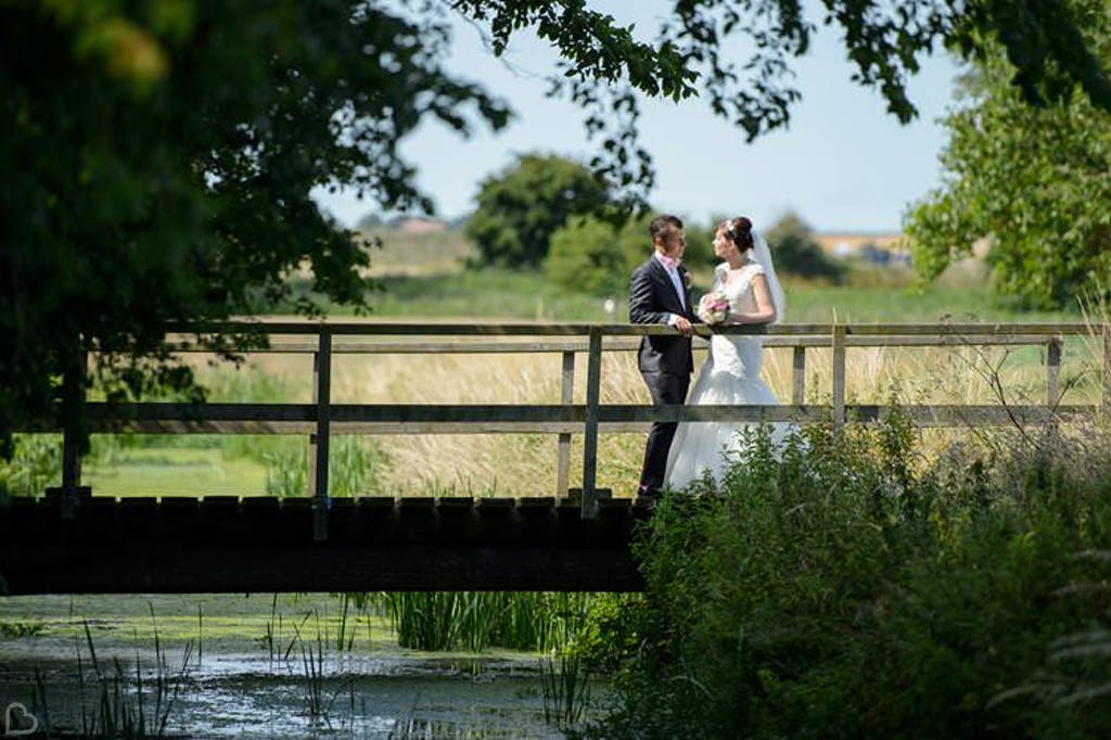 Newlyweds chat on the bride at Stoneless Golf Club, a cheap wedding venue in Kent.