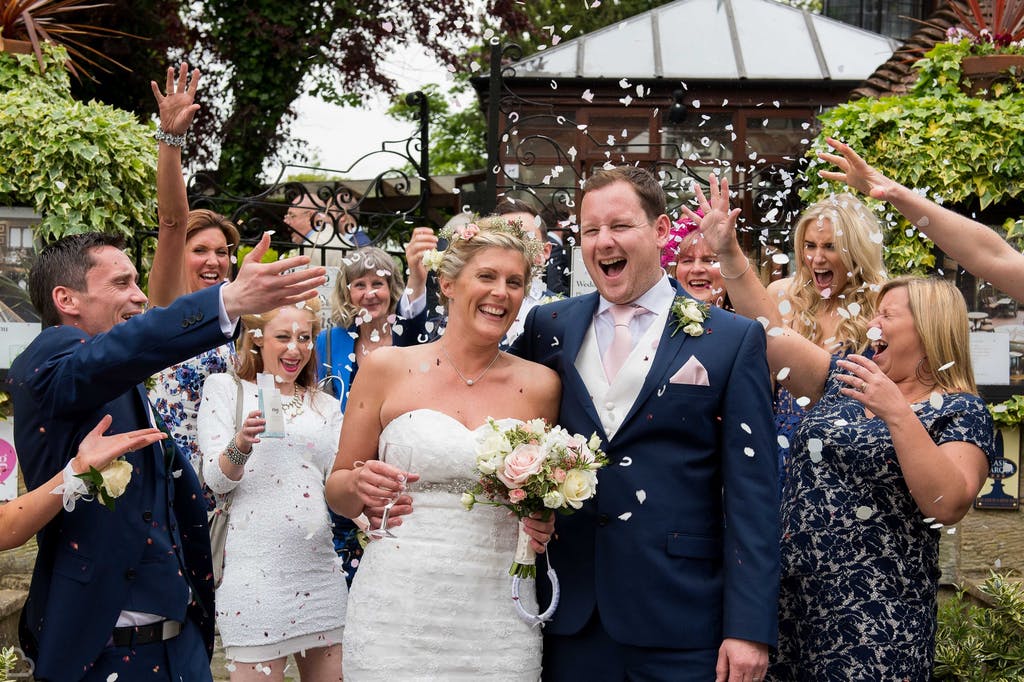 Happy newlyweds' confetti shot at The Barn.