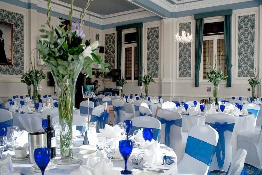 Blue and white themed wedding lunch with large vases for centrepieces.