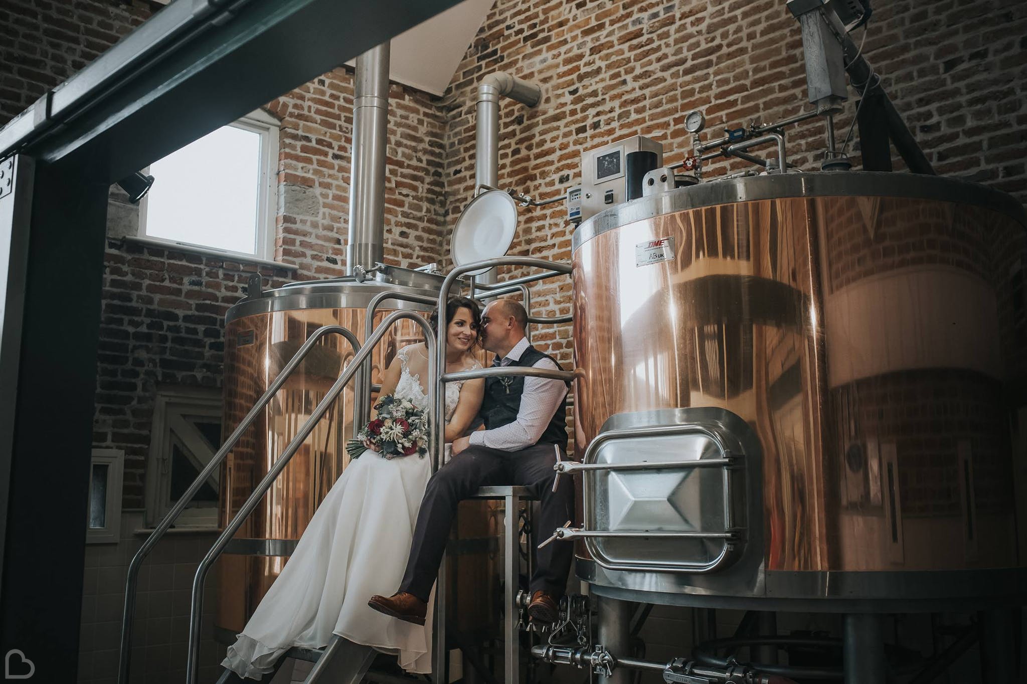 newlyweds kiss in peasantry brewery 