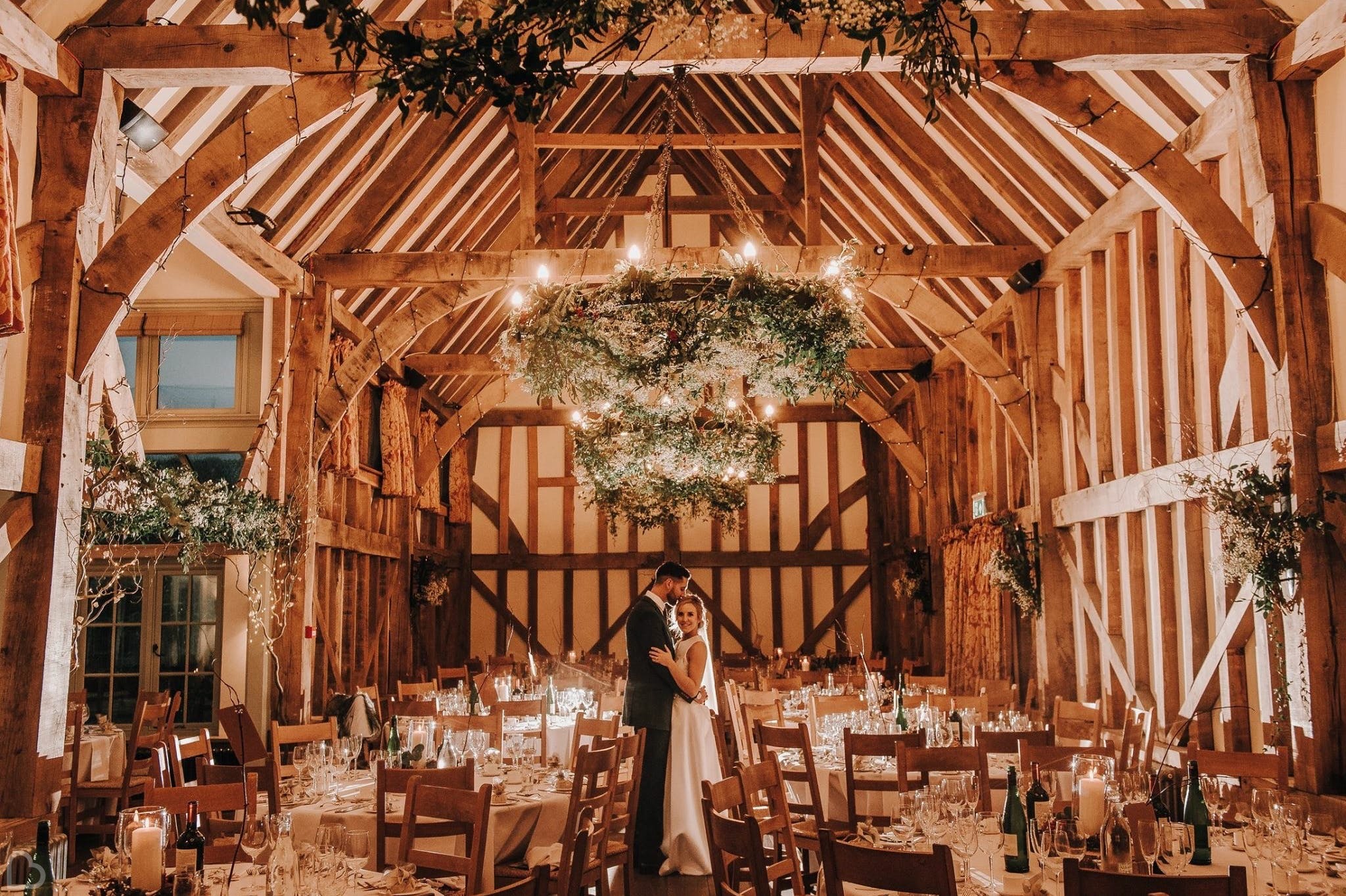 Happy newlyweds insite the barn before their wedding dinner. 