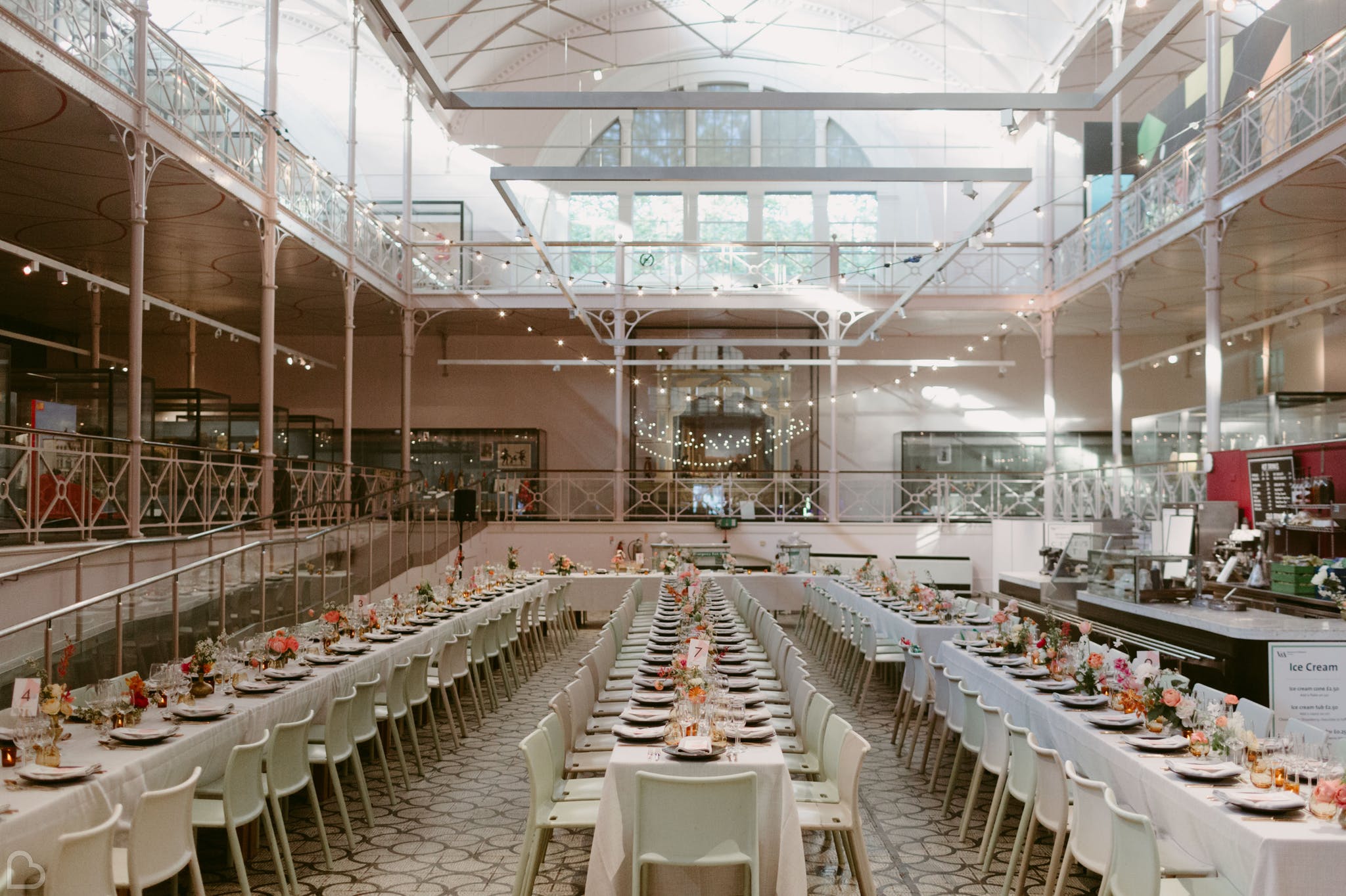 Gorgeous dinning room flooding with light and long tables.