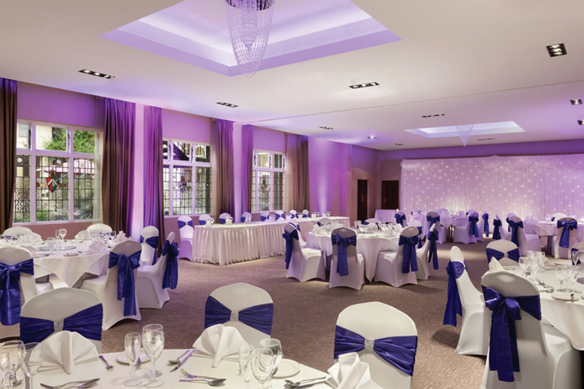 wedding dinner set up in tones of purple at ramada solihull.