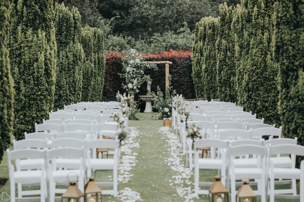 outdoors wedding ceremony amongst the trees in the holford estate.