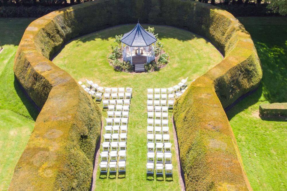 The garden gazebo surrounded by a hedge.