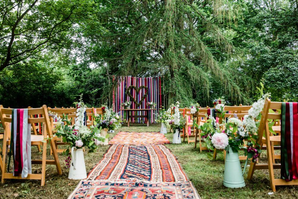 An outside ceremony is set with a festive and boho look.