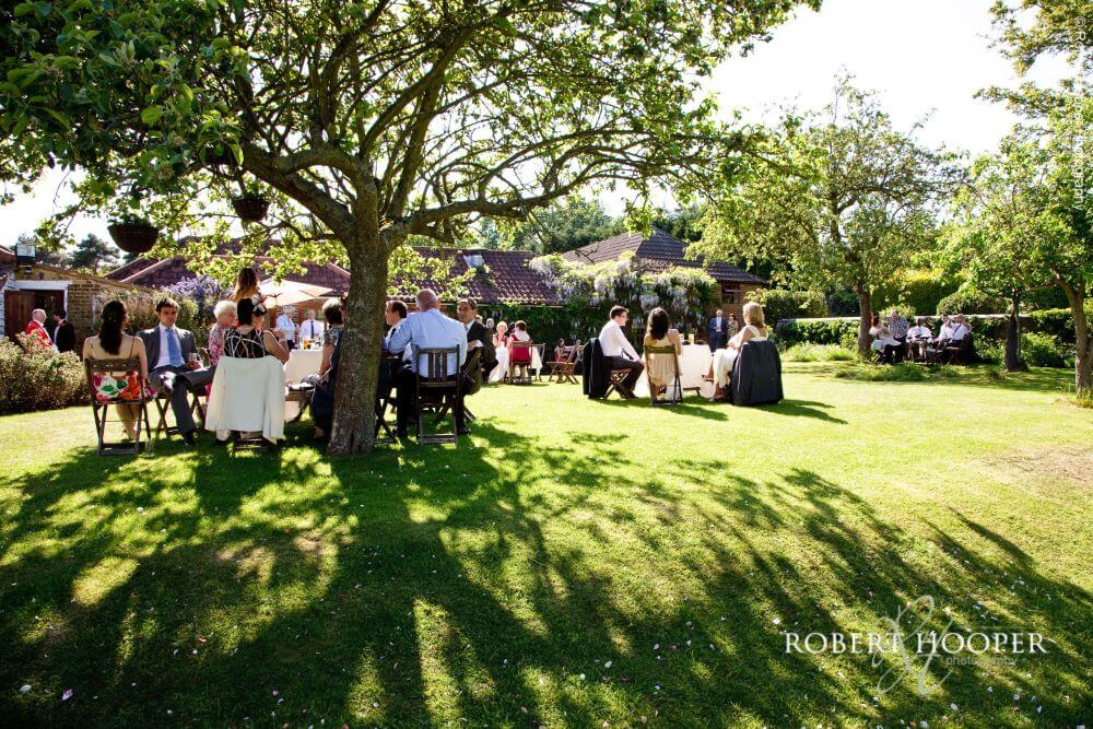 Several people sitting outside in the garden.