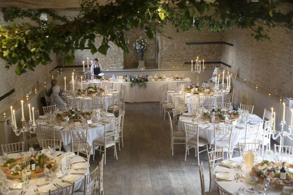 Dining area with a buffet table and six round tables decorated.