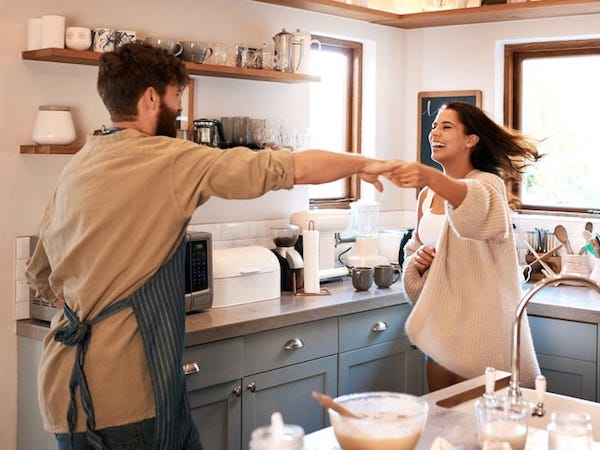 couple cooking and dancing