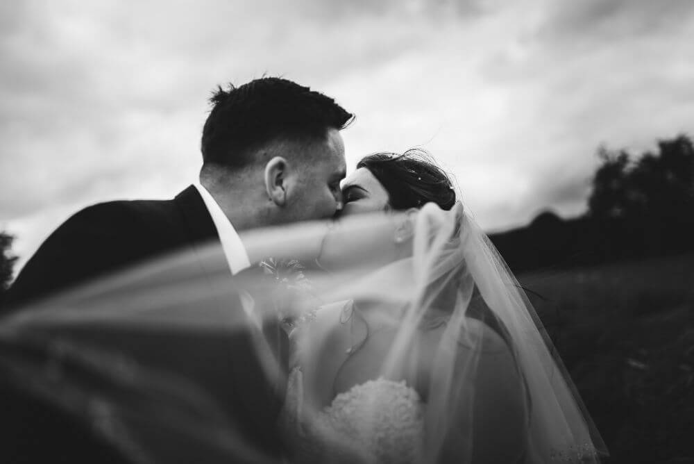 The bride and groom kissing.