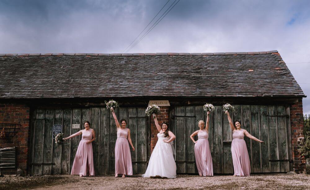 The bride and bridesmaids strike a pose with their bouquets.