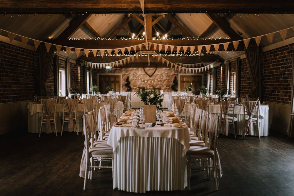 The tables are set for dinner inside the barn.