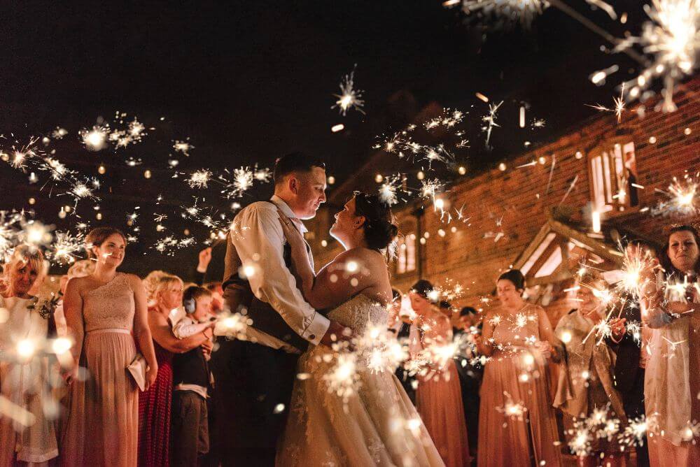 The couple stare lovingly at each other as guests look on.