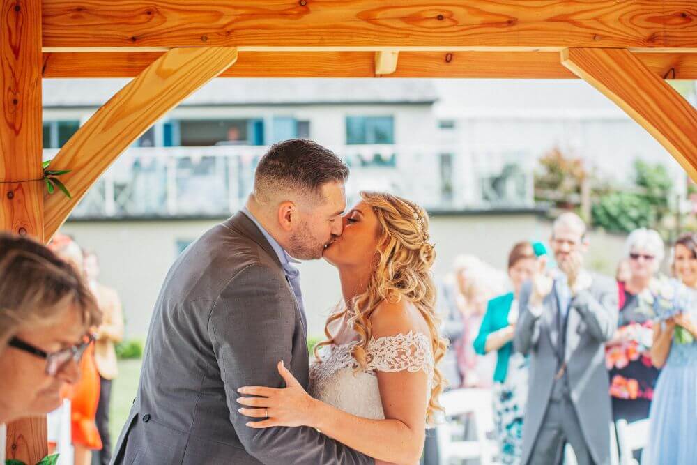 The bride and groom kiss.