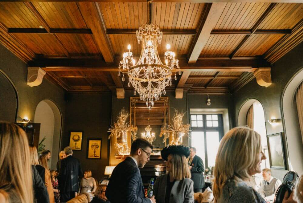 The guest inside the building, which features a chandelier hanging from a wooden ceiling.