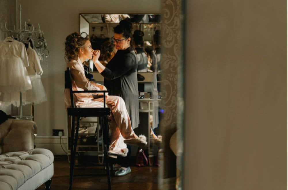 The bride getting her makeup done.