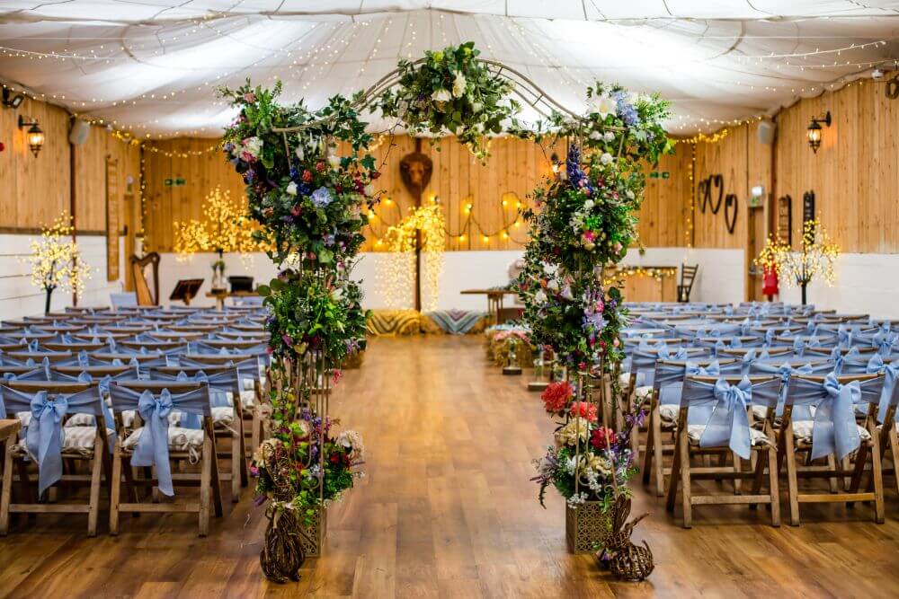 An archway is shown richly decorated with flowers.