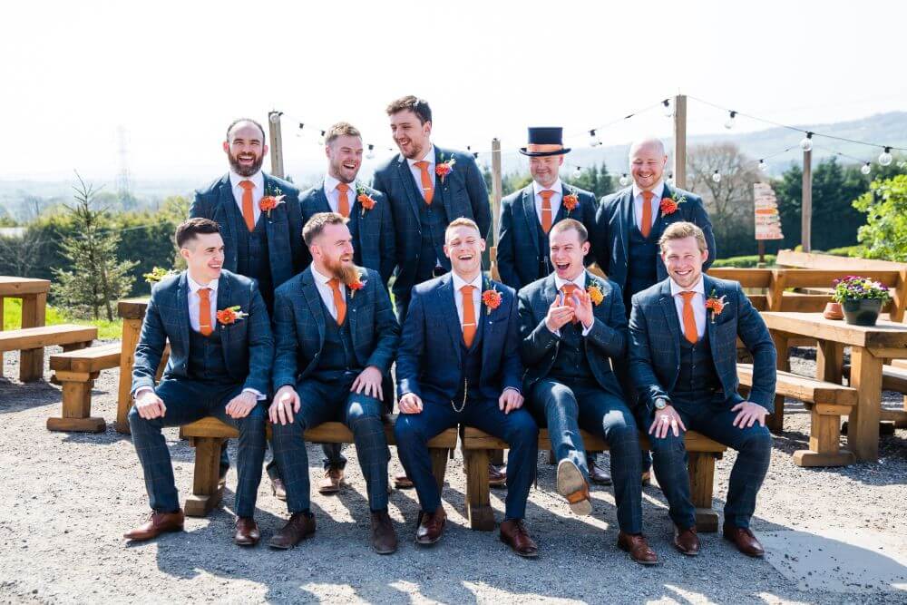 The groom posing with his groomsmen.