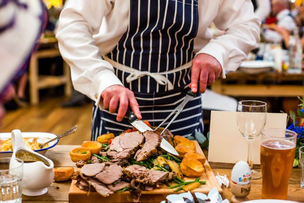 A chef cutting meat.