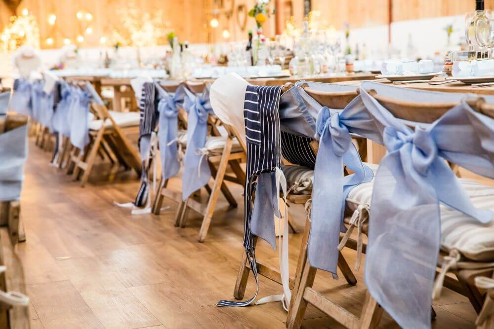 The dinner seats are decorated with blue ribbons.