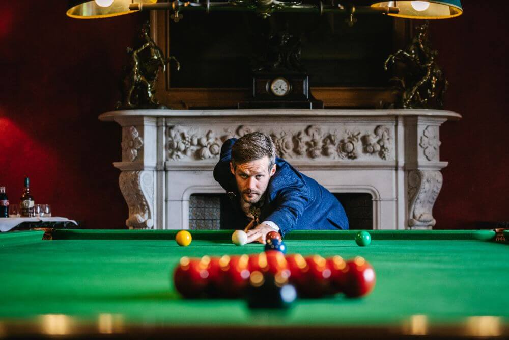 One of the guests plays pool.