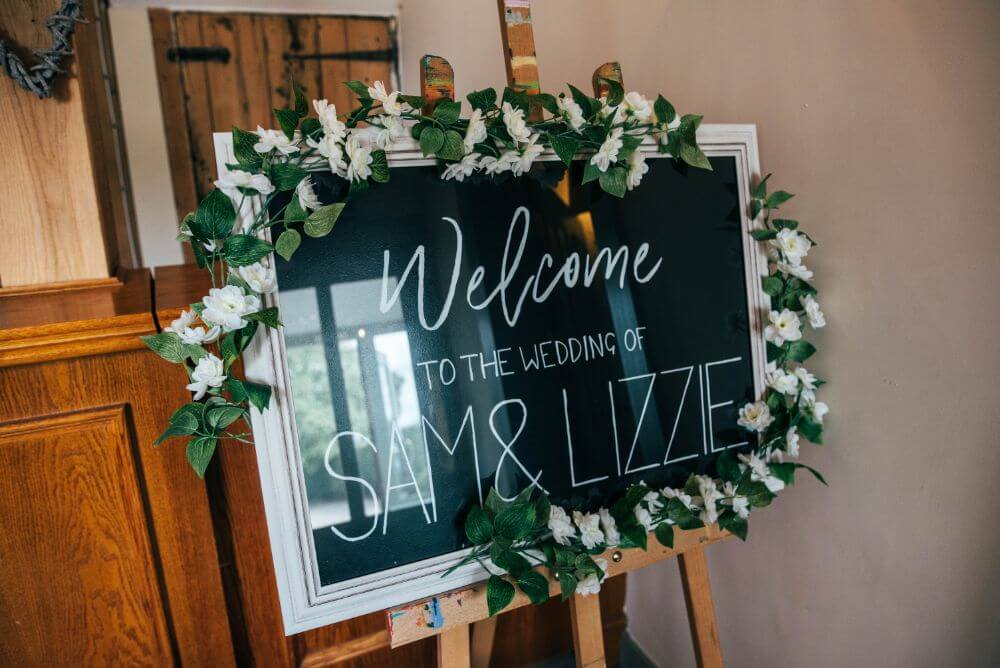 A sign that reads (Welcome to the wedding of Sam & Lizzie).