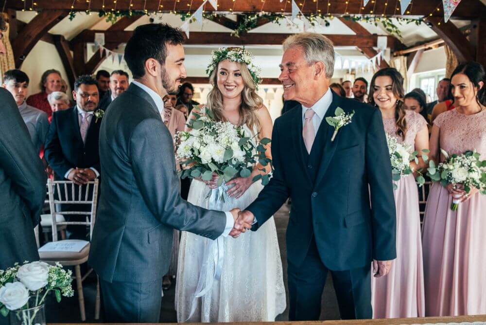 The father of the bride gives his daughter away.