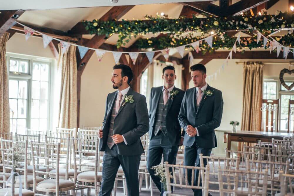 The groom and groomsmen arrive at the wedding site.