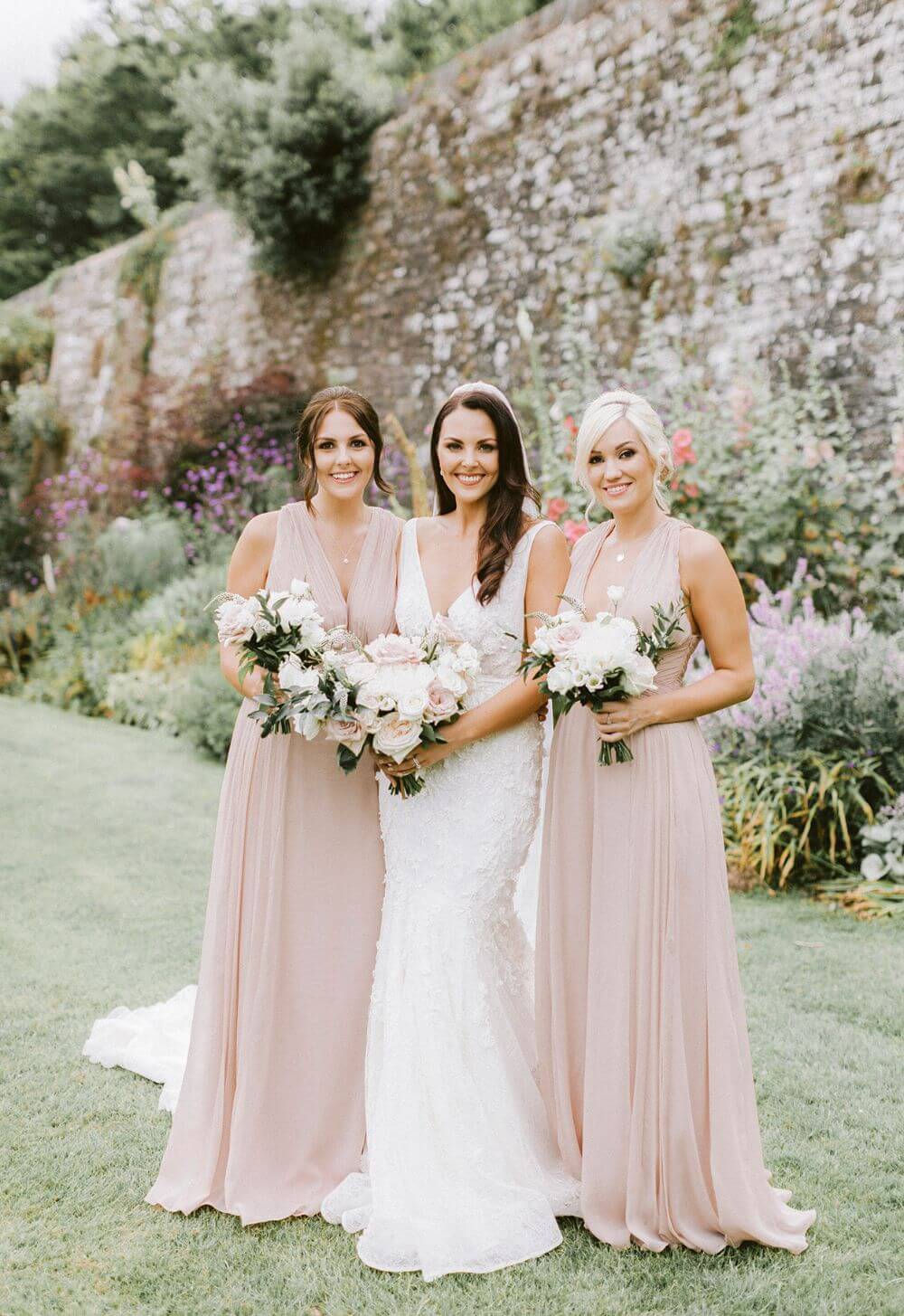 The bride posing with two bridesmaids.