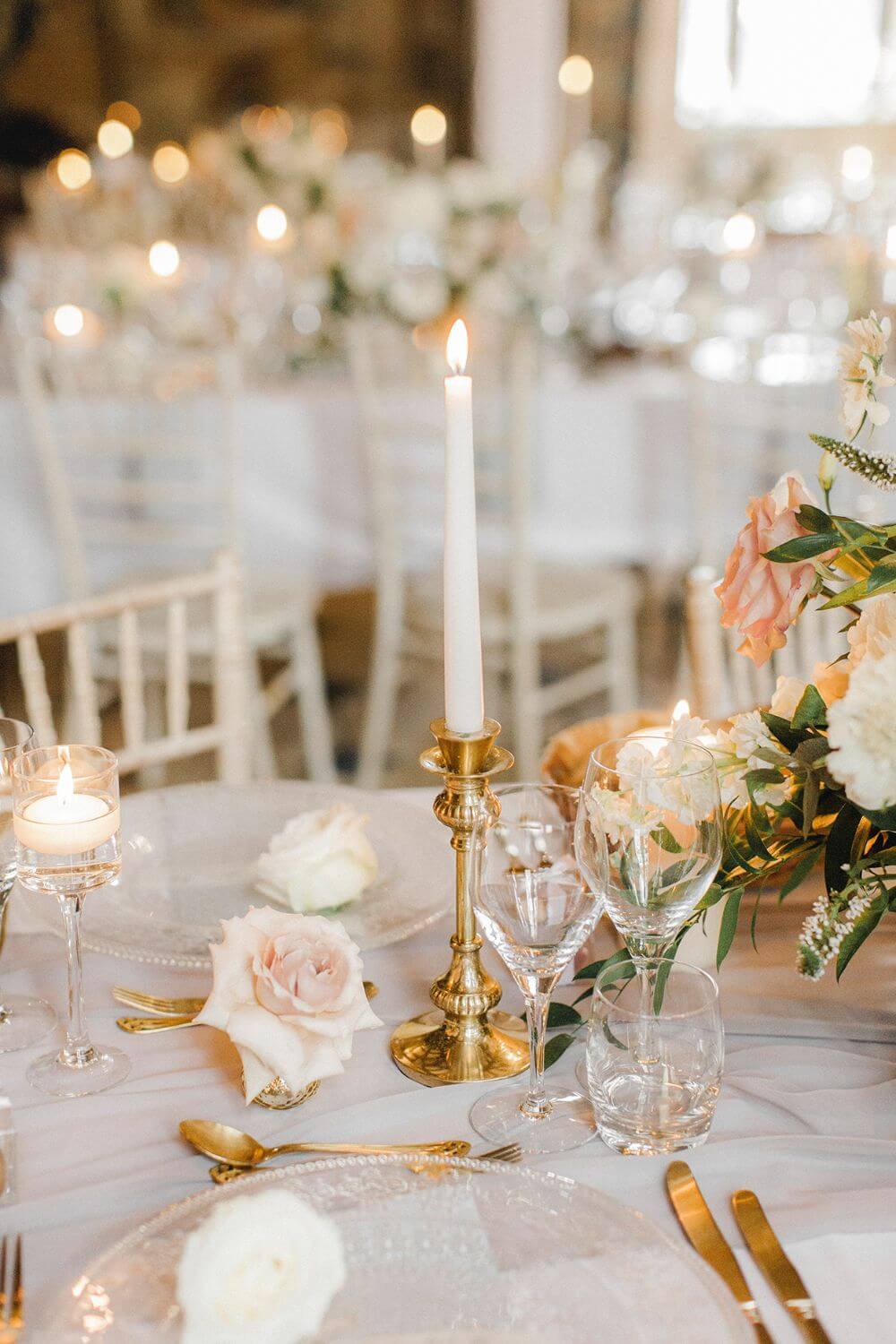 A white candle on top of a table.