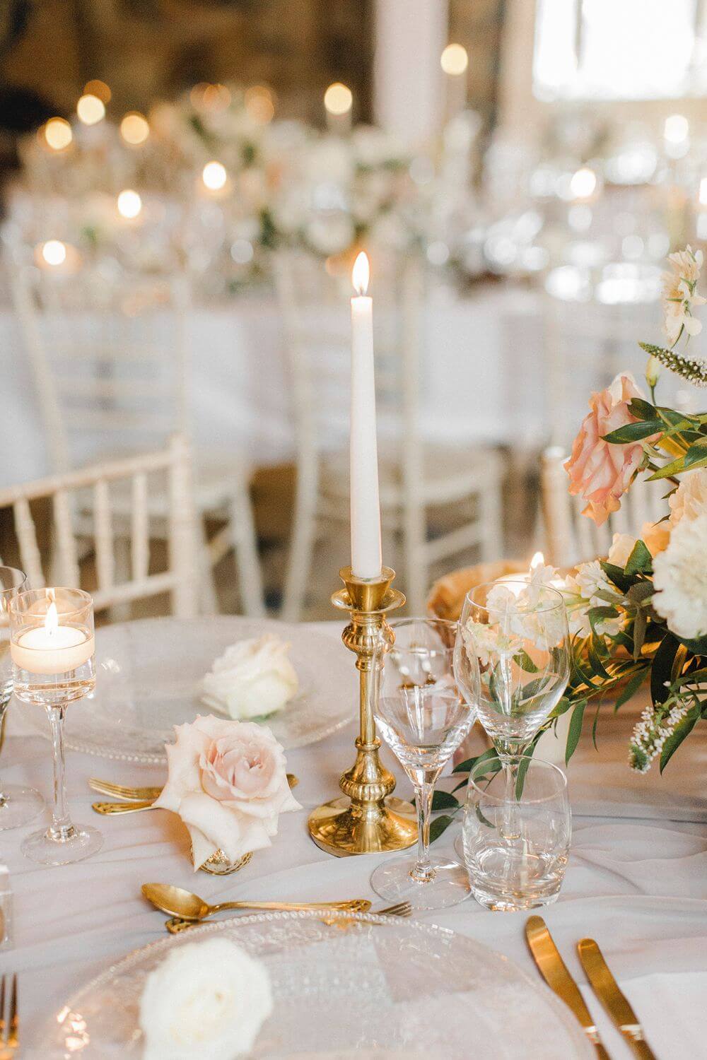 A white candle on top of a table.