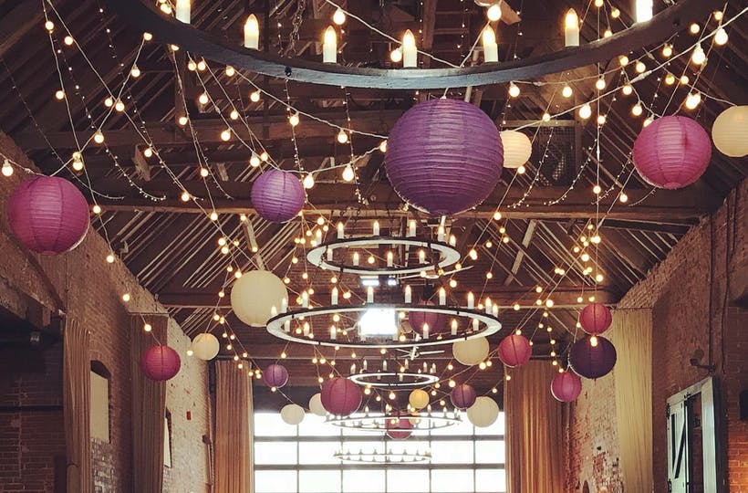 Beautiful paper lanterns hung at ceiling of barn wedding venue