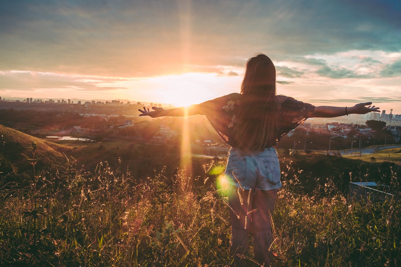 Woman happily expressing freedom in field