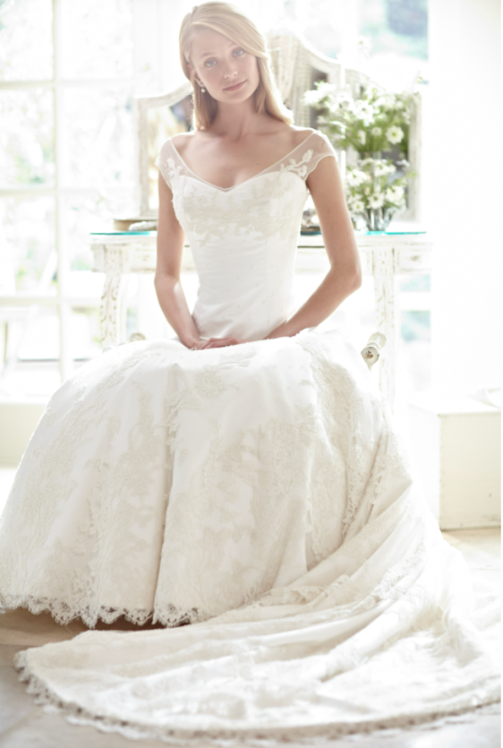 Phillipa Lepley wedding dress on model sitting with hands in lap